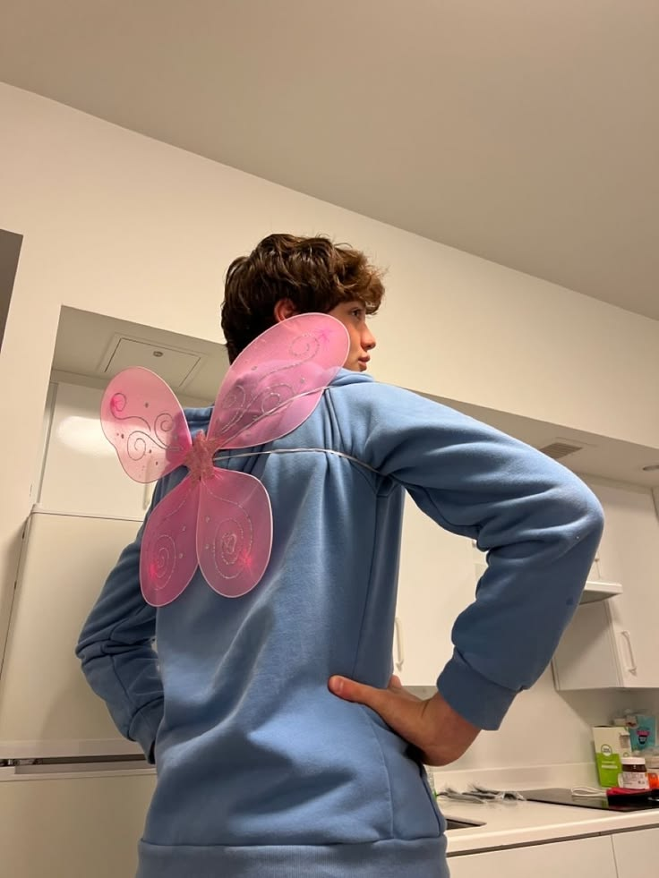 A playful costume moment with pink fairy wings